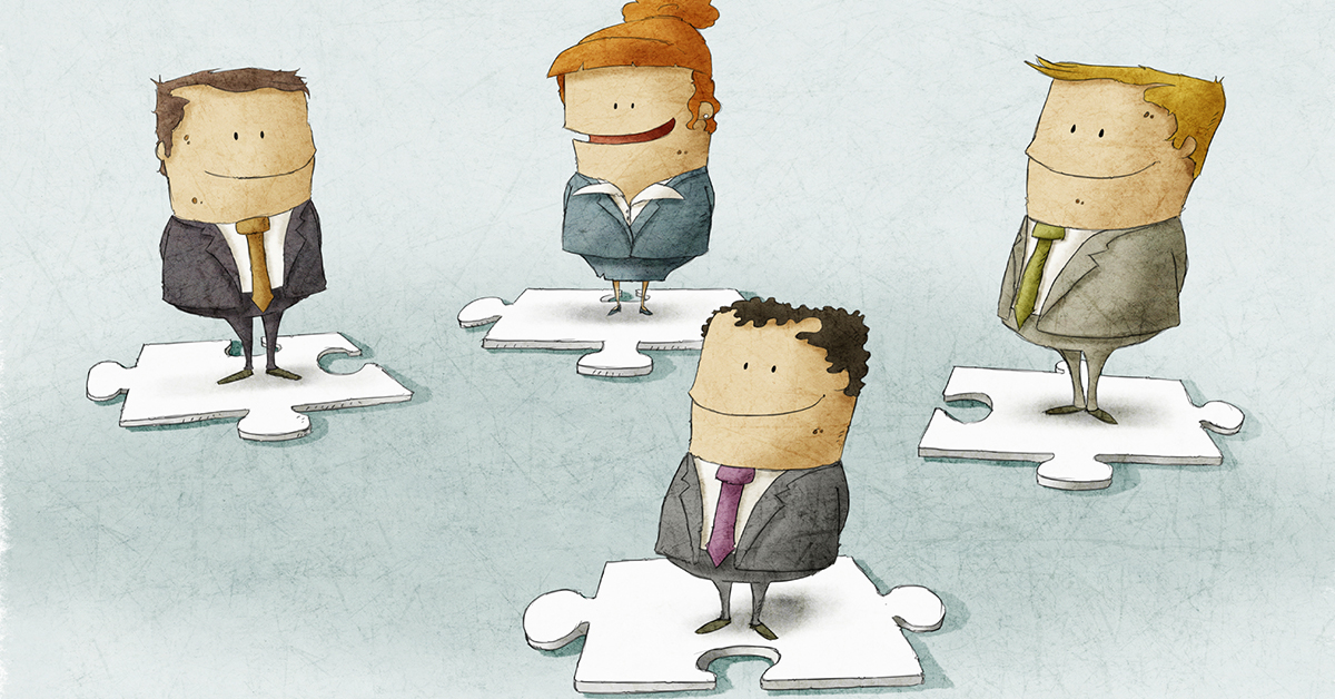 four_people_standing_puzzle_pieces